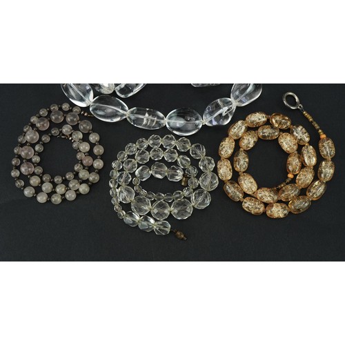 2697 - Four vintage and later necklaces including rock crystal and quartz, one with silver clasp, the large... 