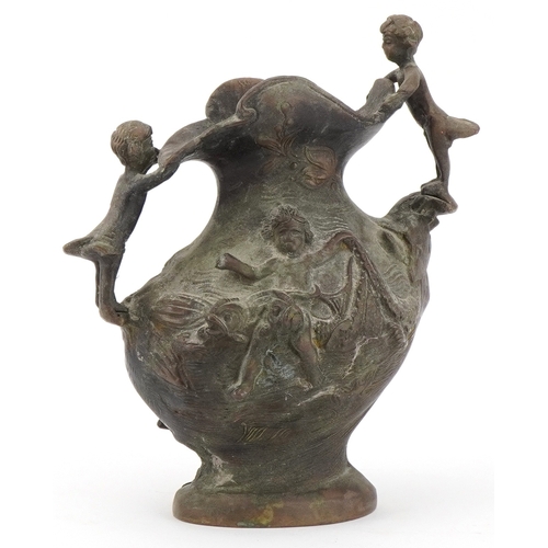 1299 - 19th century classical patinated bronze jug surmounted and decorated in relief with children and fis... 