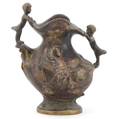 1299 - 19th century classical patinated bronze jug surmounted and decorated in relief with children and fis... 