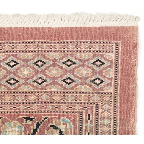 1125 - Middle Eastern beige ground rug having an allover floral design, 166cm x 97cm