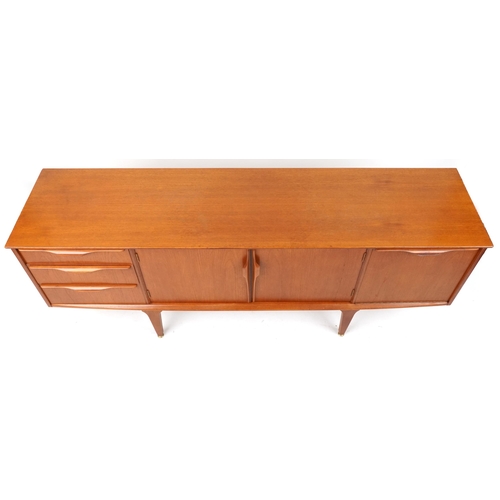 1021 - Mackintosh, mid century Scottish teak sideboard fitted with an arrangement of three drawers and thre... 