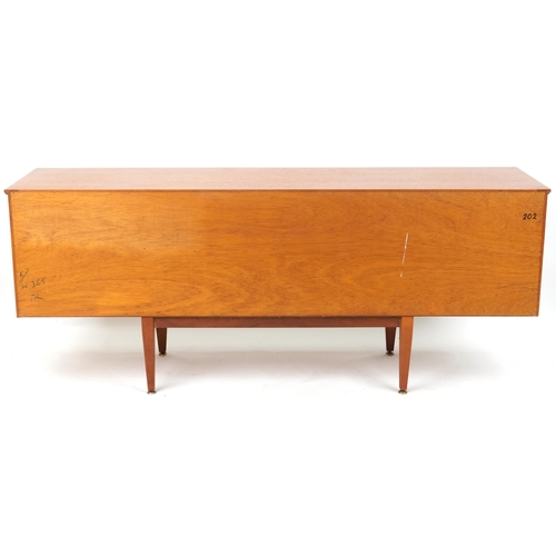 1021 - Mackintosh, mid century Scottish teak sideboard fitted with an arrangement of three drawers and thre... 