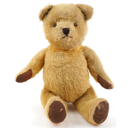 1521 - Early 20th century golden straw filled teddy bear with growler and jointed limbs, 44cm high