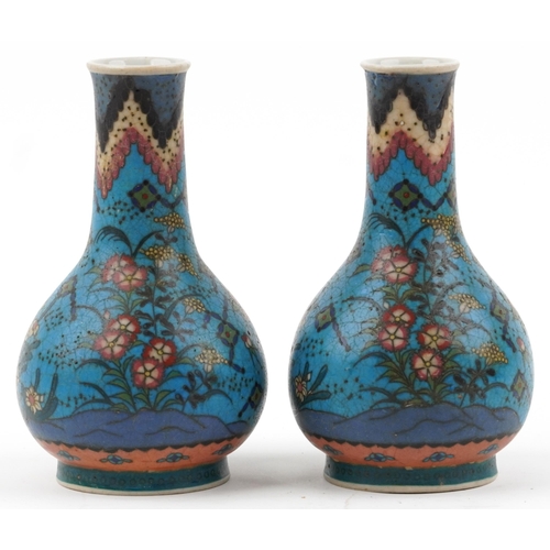 1296 - Pair of Japanese Owari shippo porcelain vases enamelled with flowers, each 19cm high