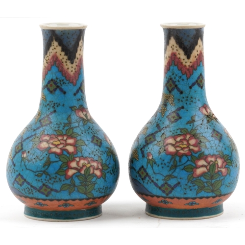 1296 - Pair of Japanese Owari shippo porcelain vases enamelled with flowers, each 19cm high