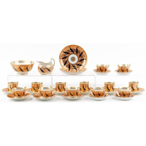 Barr Flight & Barr, early 19th century Worcester peach ground tableware gilded with catkins and foliage, comprising gravy boat, slop bowl, side plates, six coffee cans with four saucers and seven teacups with nine saucers, each with impressed marks to the base, the largest each 20cm in diameter