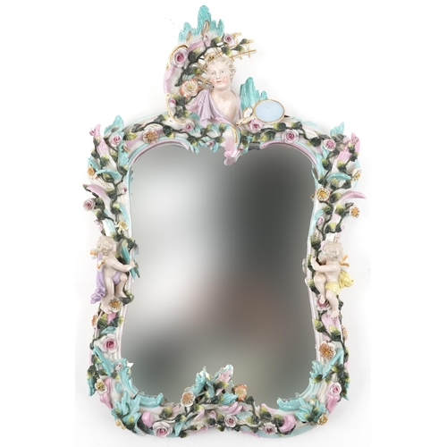 19th century German floral encrusted wall mirror surmounted with a maiden head and two Putti, 57cm x 37cm