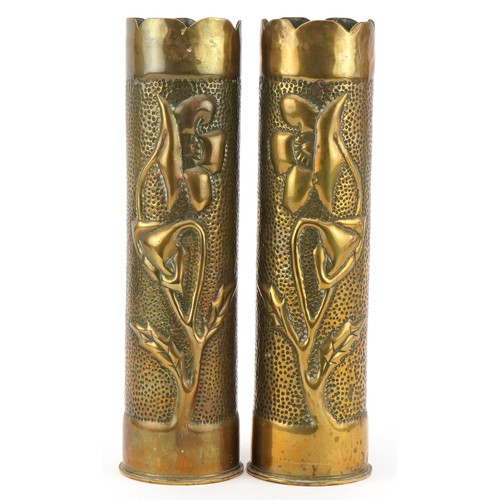 Pair of military interest World War I trench art shell cases embossed with flowers, each 31cm high