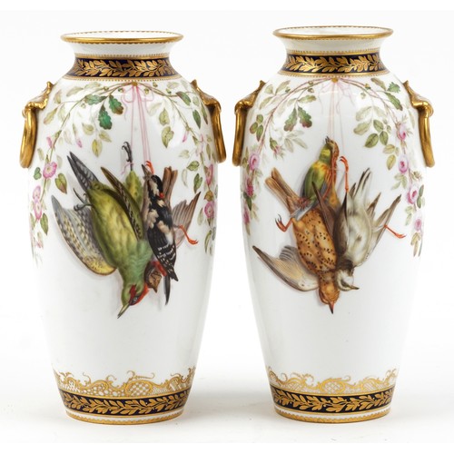 69 - Pair of 19th century European porcelain vases with ring turned handles hand painted with hanging gam... 