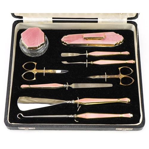 164 - Davis Moss & Co, Art Deco silver gilt and pink guilloche enamel manicure/vanity set housed in a velv... 