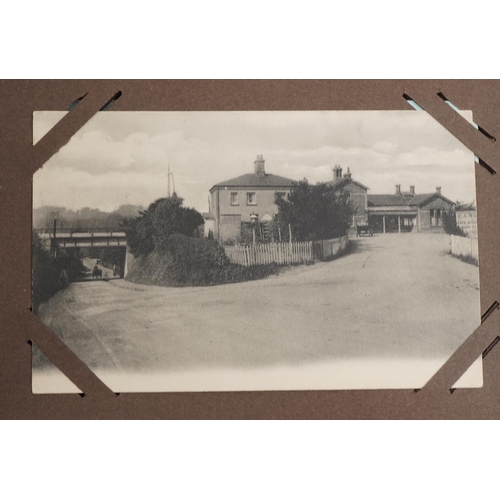 673 - Local interest and railwayana postcards arranged in an album including Eastbourne Railway Station an... 