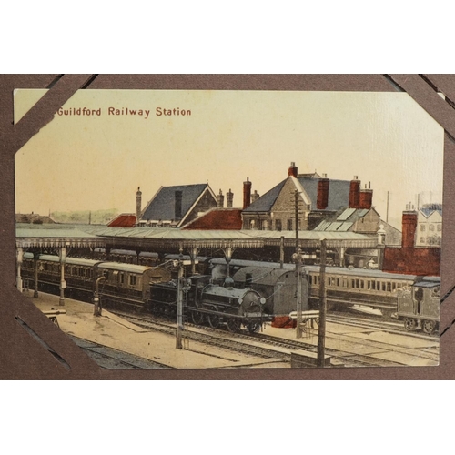 673 - Local interest and railwayana postcards arranged in an album including Eastbourne Railway Station an... 