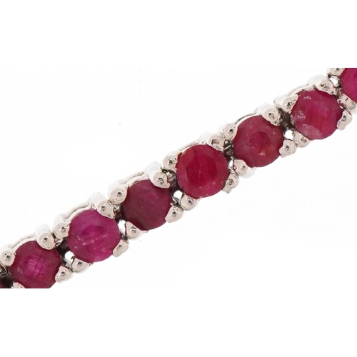 2181 - Silver ruby line bracelet, each ruby approximately 2.80mm in diameter, 18cm in length, 15.0g