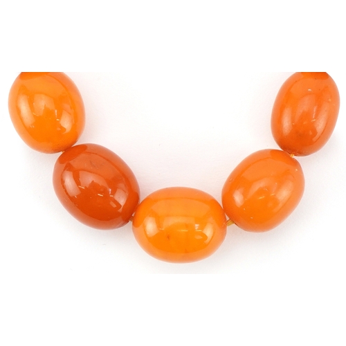 2021 - Butterscotch amber coloured graduated bead necklace, the largest bead approximately 18mm x 15mm in d... 