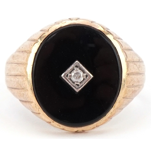 2424 - 9ct gold black onyx signet ring set with a clear stone, size R, 5.0g