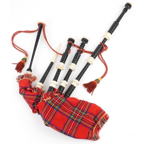 1247 - Set of Scottish interest bagpipes, various kilts and an as new sporran with stag's head