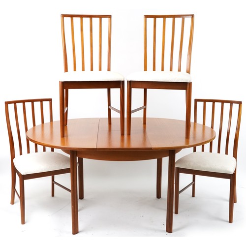 1073 - Mackintosh, mid century Scottish teak circular extending dining table with four chairs, the table 72... 