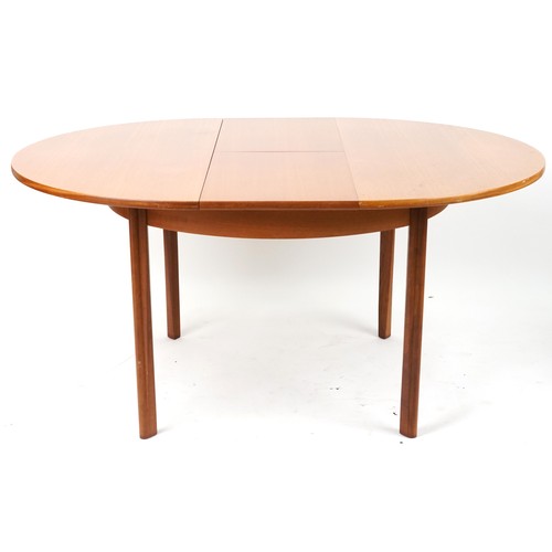 1073 - Mackintosh, mid century Scottish teak circular extending dining table with four chairs, the table 72... 