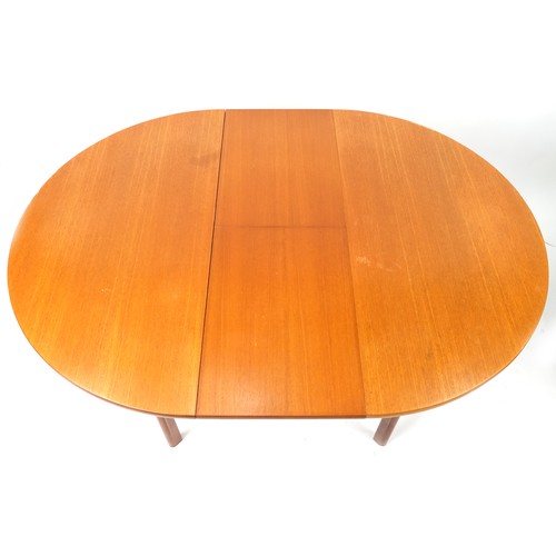 1073 - Mackintosh, mid century Scottish teak circular extending dining table with four chairs, the table 72... 