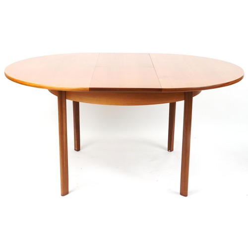 1073 - Mackintosh, mid century Scottish teak circular extending dining table with four chairs, the table 72... 
