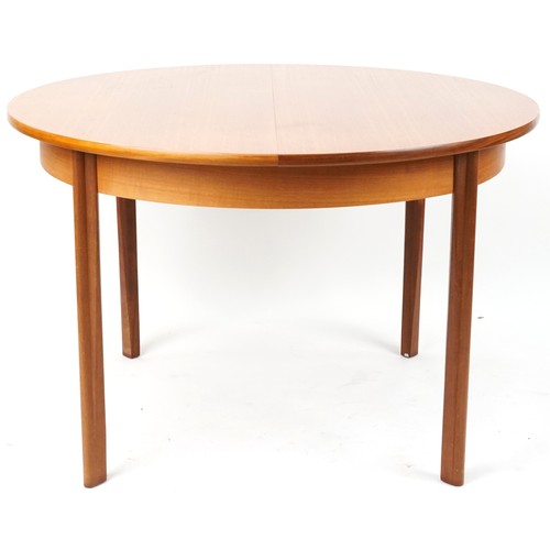 1073 - Mackintosh, mid century Scottish teak circular extending dining table with four chairs, the table 72... 