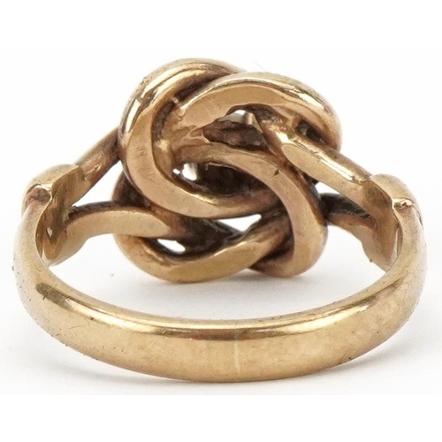 2370 - 9ct gold knot design ring set with a clear stone, size P, 5.2g