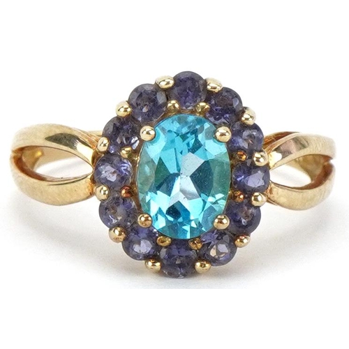 2072 - 9ct gold blue topaz and purple stone cluster ring with split shoulders, the topaz approximately 8.05... 