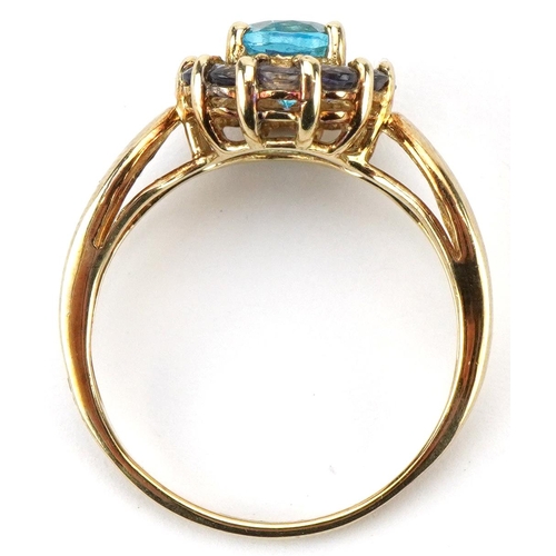 2072 - 9ct gold blue topaz and purple stone cluster ring with split shoulders, the topaz approximately 8.05... 