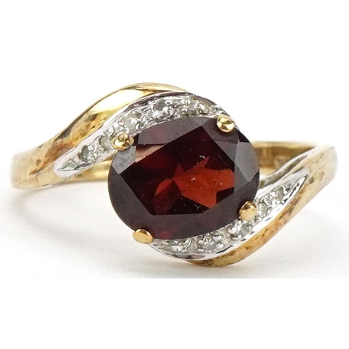 2226 - 9ct gold garnet and diamond crossover ring, the garnet approximately 9.05mm x 7.05mm x 4.40mm deep, ... 