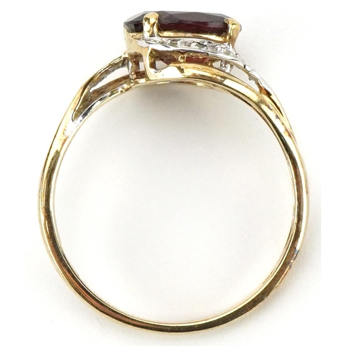 2226 - 9ct gold garnet and diamond crossover ring, the garnet approximately 9.05mm x 7.05mm x 4.40mm deep, ... 