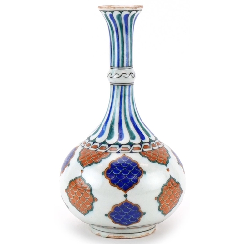 396 - Turkish Ottoman Iznik surahi hand painted with stylised leaves, 33cm high