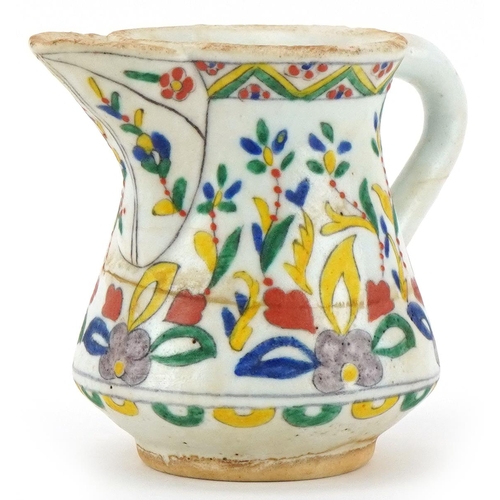 401 - Turkish Ottoman Kutahya milk jug hand painted with stylised flowers, 11cm high