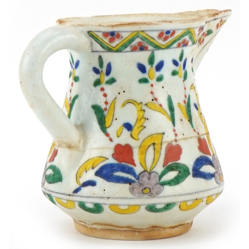 401 - Turkish Ottoman Kutahya milk jug hand painted with stylised flowers, 11cm high