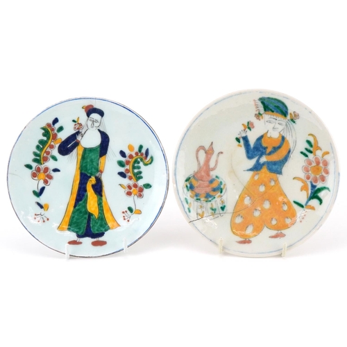 403 - Two Turkish Ottoman Kutahya dishes hand painted with figures in traditional dress and flowers, the l... 