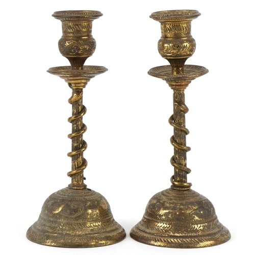 384 - Pair of Indian brass serpent candlesticks engraved with flowers and mythical birds, each 18cm high