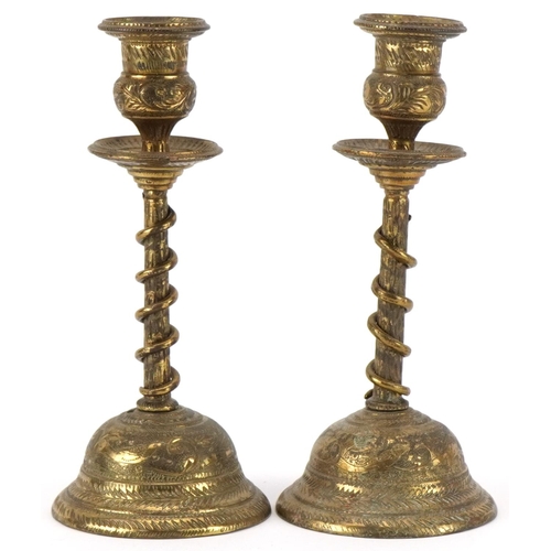 384 - Pair of Indian brass serpent candlesticks engraved with flowers and mythical birds, each 18cm high