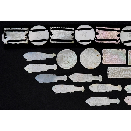 202 - Chinese Canton mother of pearl gaming counters, some arranged on a belt including examples of fish, ... 