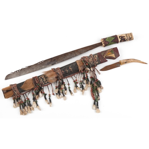 529 - African Dayak head hunter's sword with horn handle and painted hardwood sheath, Mandau, 65cm in leng... 