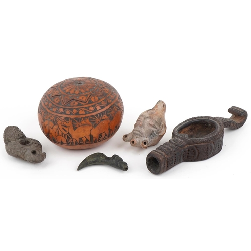 527 - Tribal artefacts including a zoomorphic bronze spout in the form of a dog's head, Peruvian folk art ... 