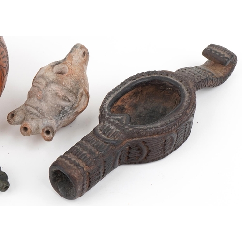 527 - Tribal artefacts including a zoomorphic bronze spout in the form of a dog's head, Peruvian folk art ... 