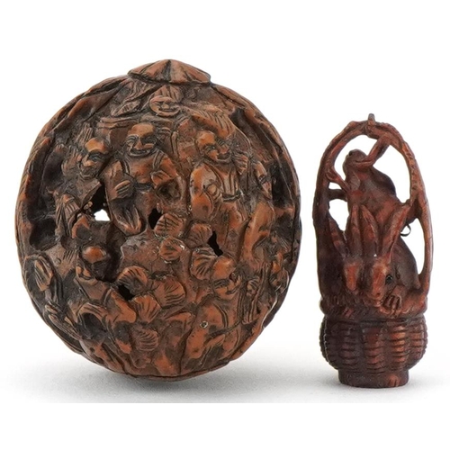 198 - Chinese walnut carved with figures and a Japanese boxwood netsuke carved with three rabbits in a bas... 