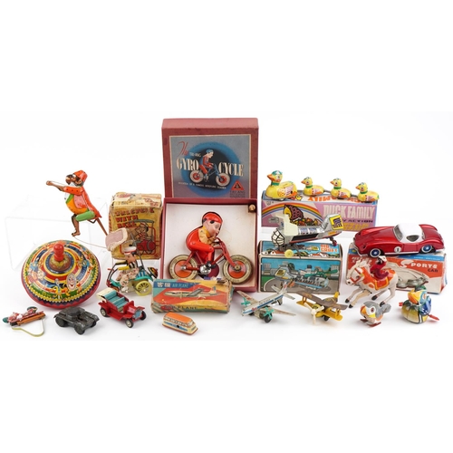 Vintage and later tinplate toys including Tri-ang Giro Cycle with box, Japanese friction driven aeroplane with box and a comical monkey