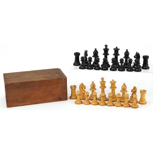 1501 - Boxwood and ebony Staunton pattern chess set housed in a pine case with slide lid, the largest piece... 