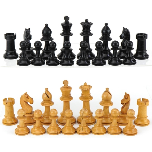 1501 - Boxwood and ebony Staunton pattern chess set housed in a pine case with slide lid, the largest piece... 