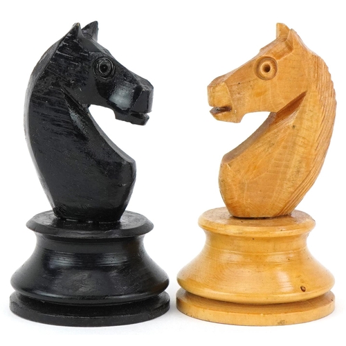 1501 - Boxwood and ebony Staunton pattern chess set housed in a pine case with slide lid, the largest piece... 