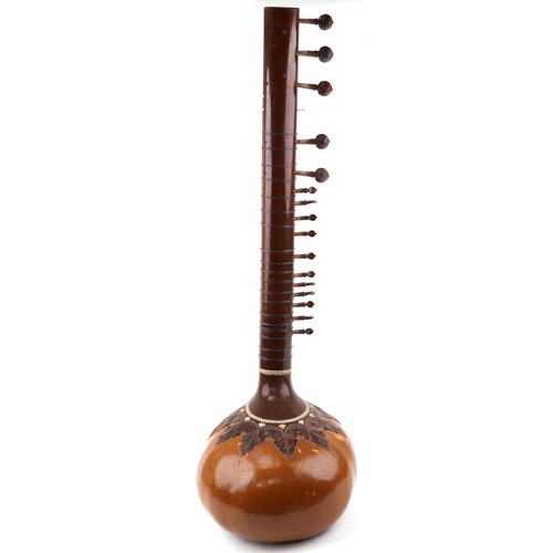 1242 - Indian hardwood, nut, ivorine and bone four string sitar, 126cm in length