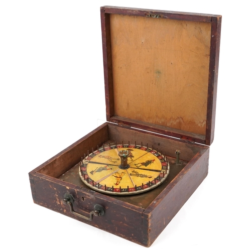 Early 20th century hardwood and bronze roulette wheel decorated with figures, housed in a hardwood case with carrying handle, the roulette wheel 35cm x 35cm