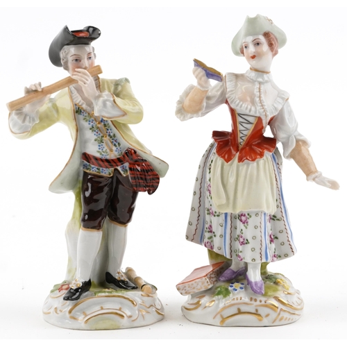 66 - Pair of Dresden German porcelain figures of a female holding a book and a gentleman playing a flute,... 