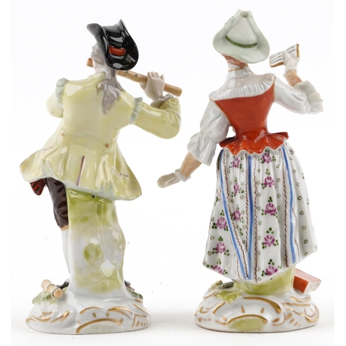 66 - Pair of Dresden German porcelain figures of a female holding a book and a gentleman playing a flute,... 