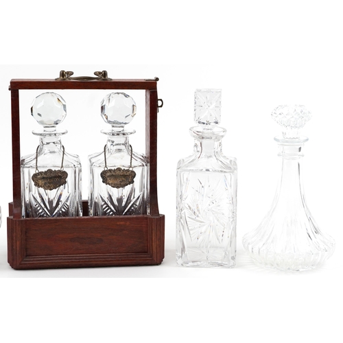 1188 - Six glass decanters including a pair housed in a hardwood tantalus with bronze mounts and silver pla... 